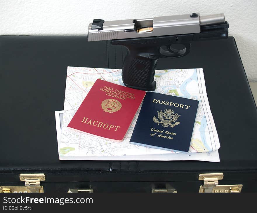 Gun and two passports with map and case for russian spy