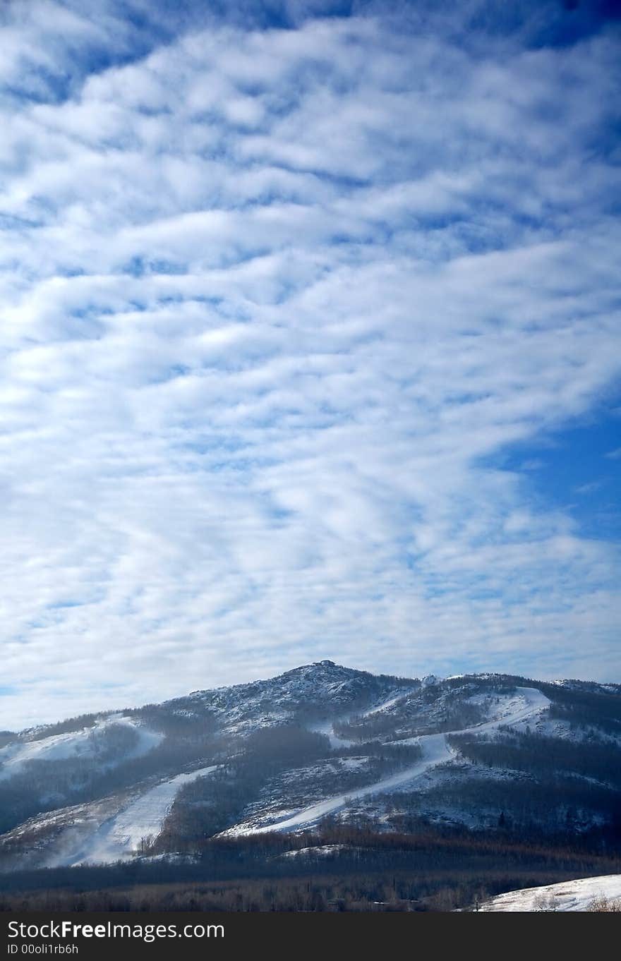 Ski slope under the light cloudy sky. Ski slope under the light cloudy sky