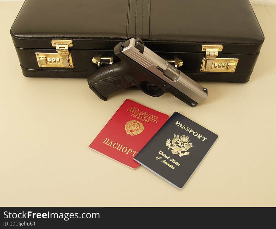 Two passports and gun with suitcase for special agent. Two passports and gun with suitcase for special agent