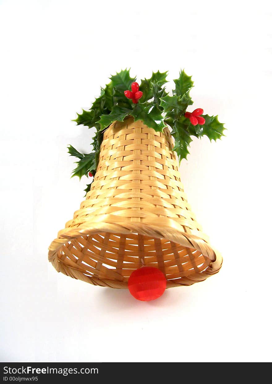 Straw decorative bell with leaves and berries as Christmas decoration