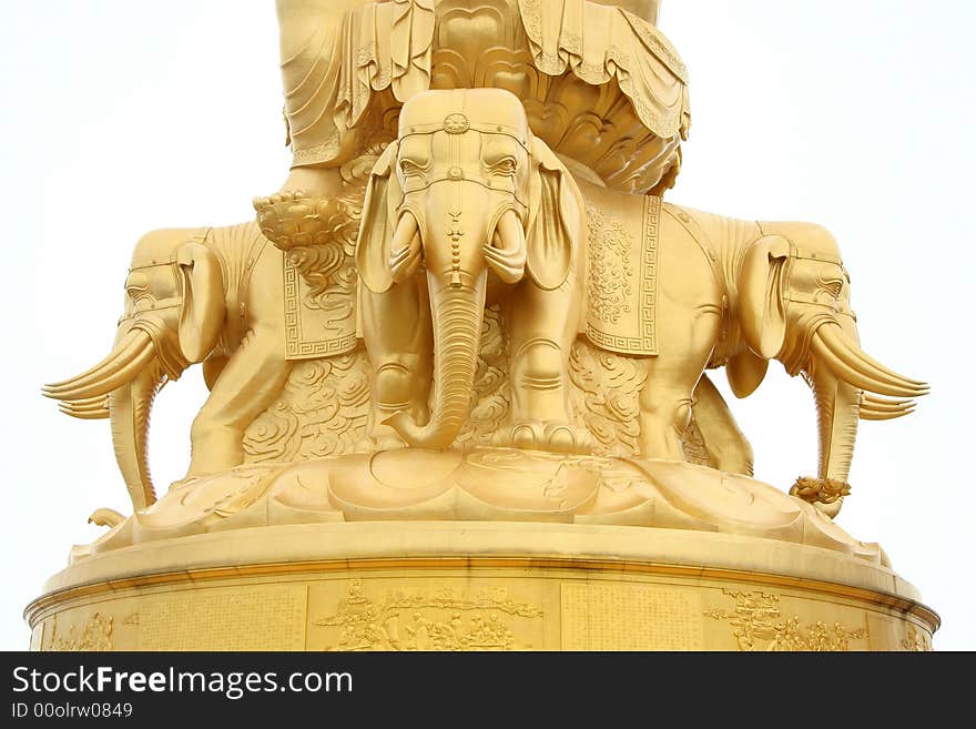 Four elephants stand at base frame of enormous golden Buddha statue a top of Emeishan mountain, China