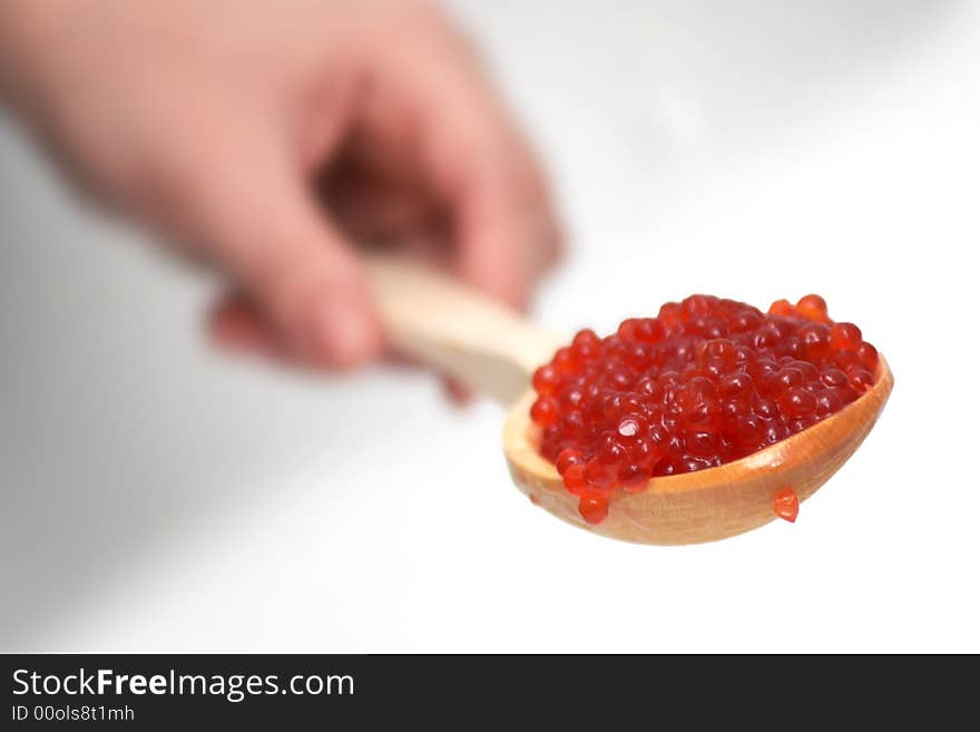 Red caviar in a wooden spoon. Red caviar in a wooden spoon