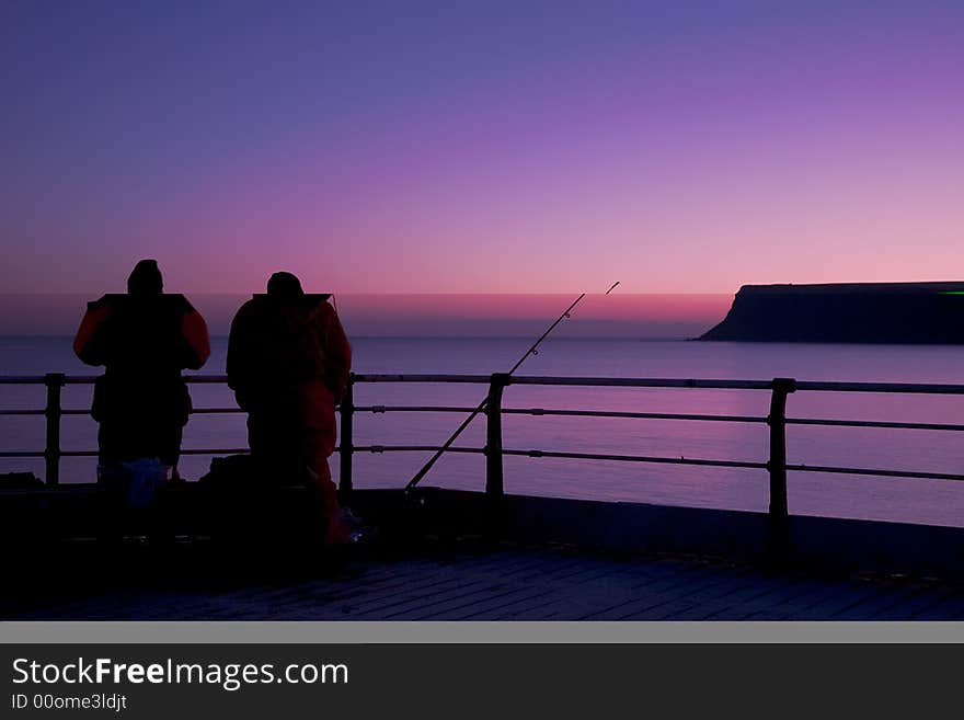 A cold still winters morn sees a lone fisherman patiently awaiting a bite. A cold still winters morn sees a lone fisherman patiently awaiting a bite