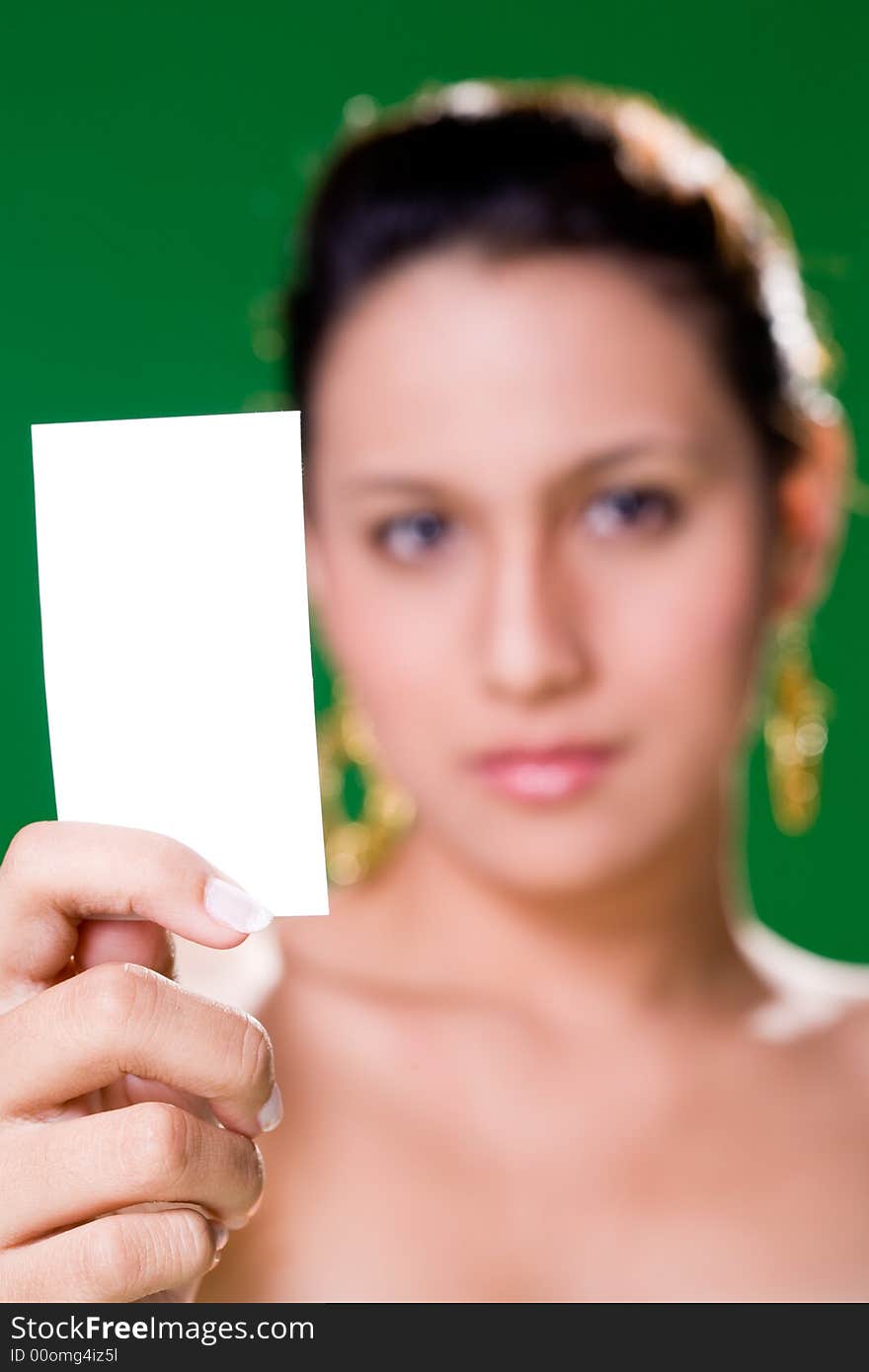 Beautiful girl holding white card on green background. Beautiful girl holding white card on green background