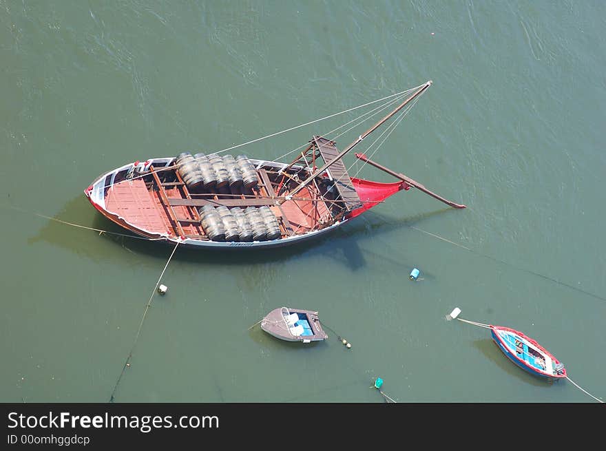 Boat in the rive douro, in Portugal, Porto city with the barrels for transporting the vine. Boat in the rive douro, in Portugal, Porto city with the barrels for transporting the vine.