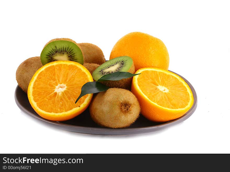 Kiwis and orange on white background