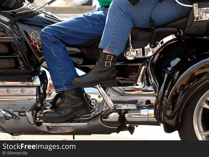 The side view of a motorcycle with two riders in a parade