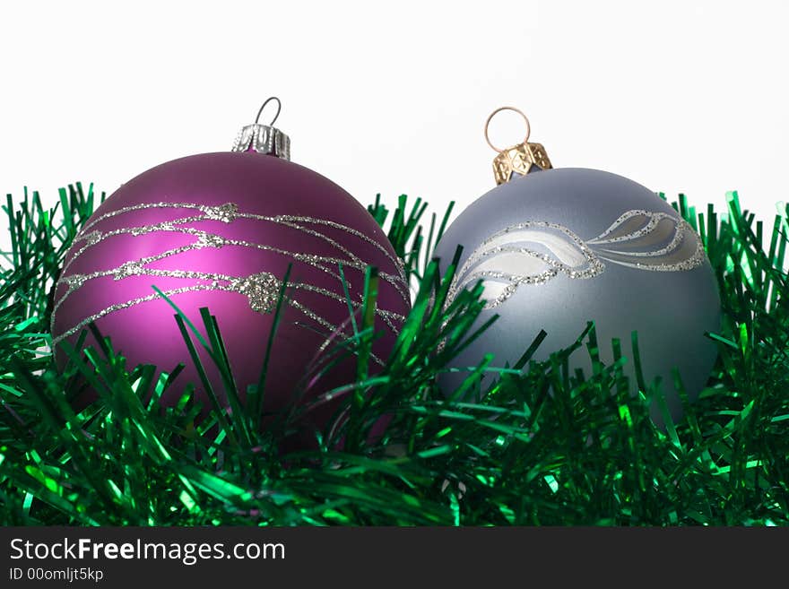 Two fur-tree toys on green garland and white background