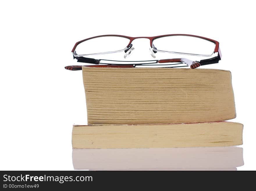 Glasses, specs, spectacles on pile of books