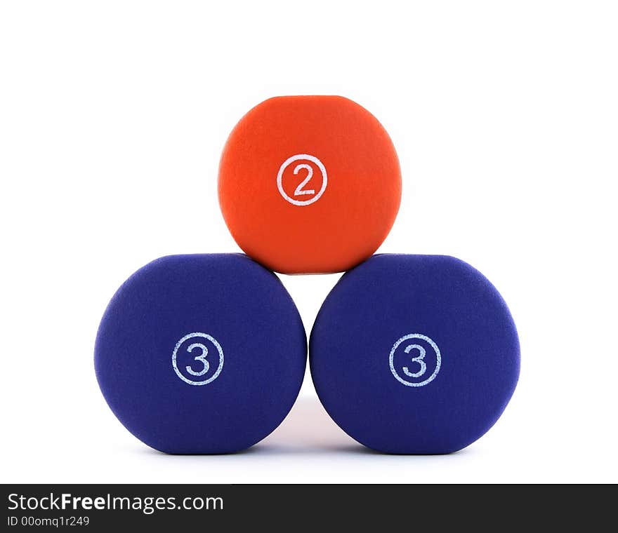 Pyramid made of thee dumbbells. White background. Pyramid made of thee dumbbells. White background.