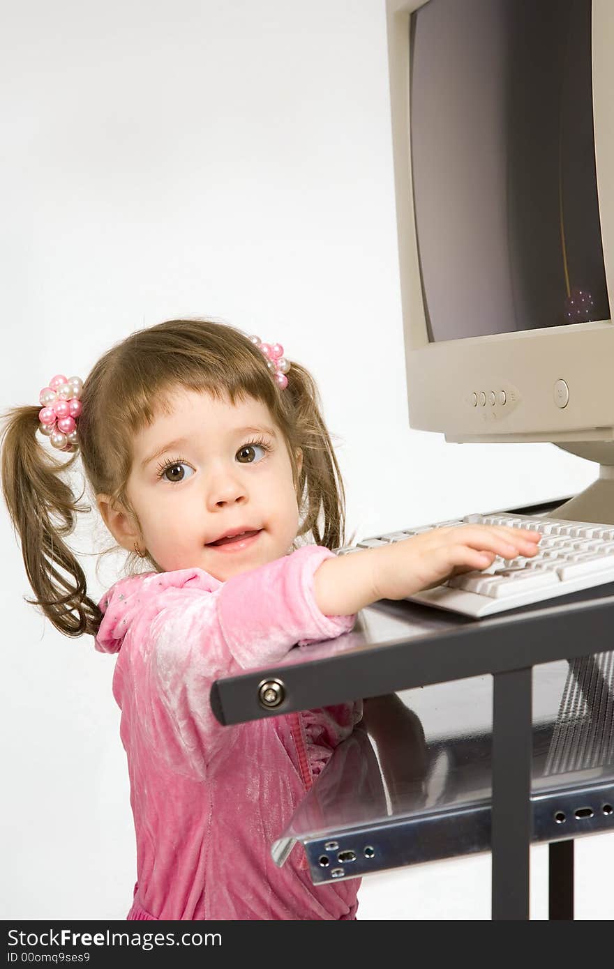 Cute little girl tuching keyboard. Cute little girl tuching keyboard