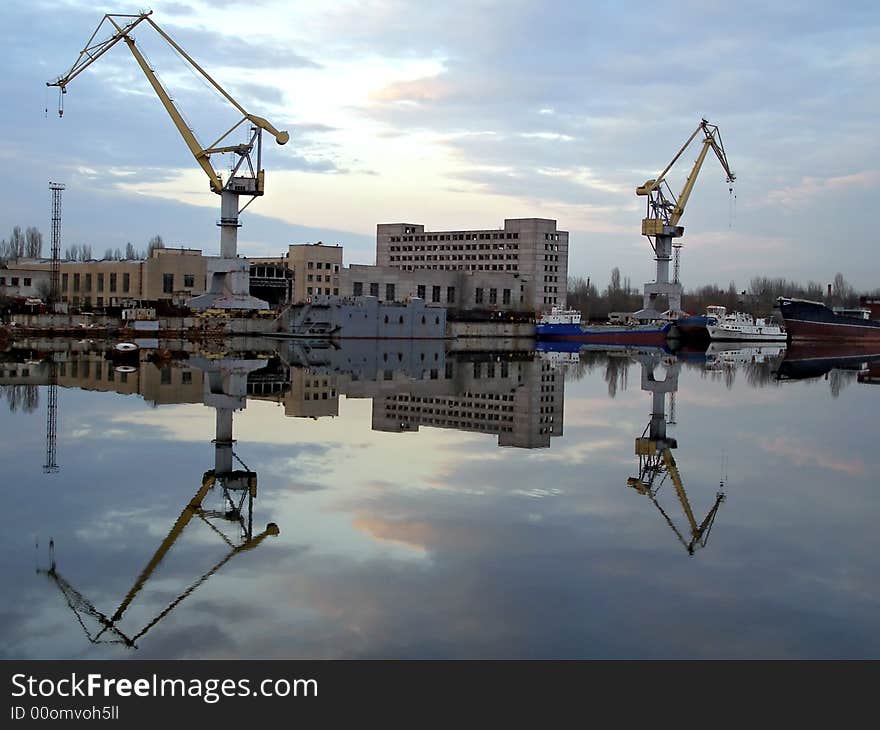 Shipyard view reflected in water