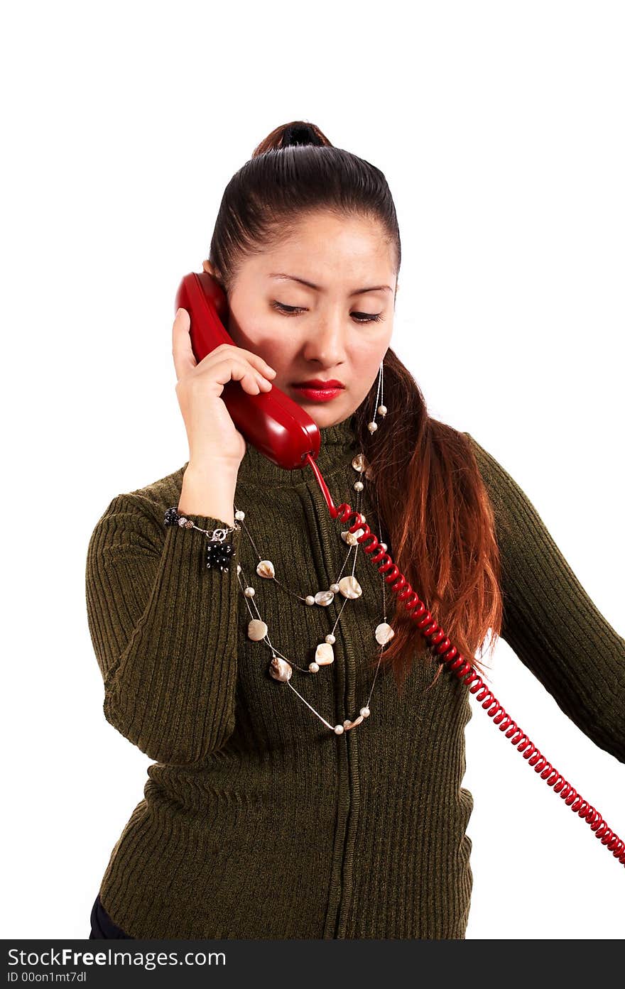 A young female talking on the phone looking unhappy. A young female talking on the phone looking unhappy