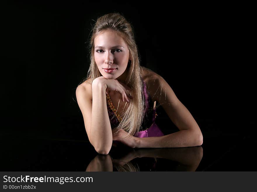 The young girl on a black background. The young girl on a black background