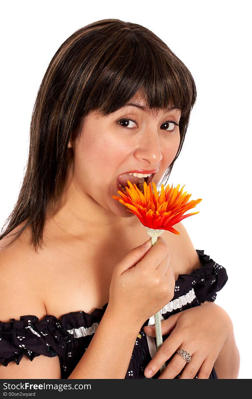 A young woman trying to eat a flower