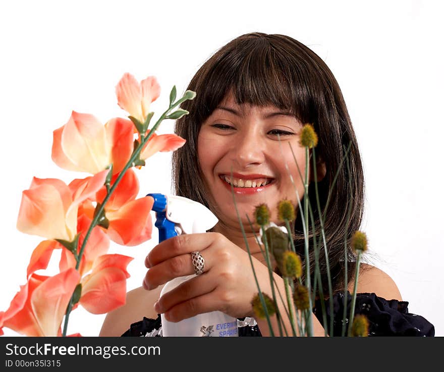 Young woman in black top watering fresh flower. Young woman in black top watering fresh flower