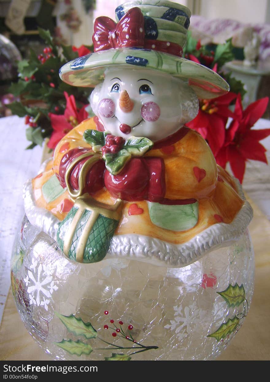 Snowman cookie jar with a poinsetta plant. Snowman cookie jar with a poinsetta plant