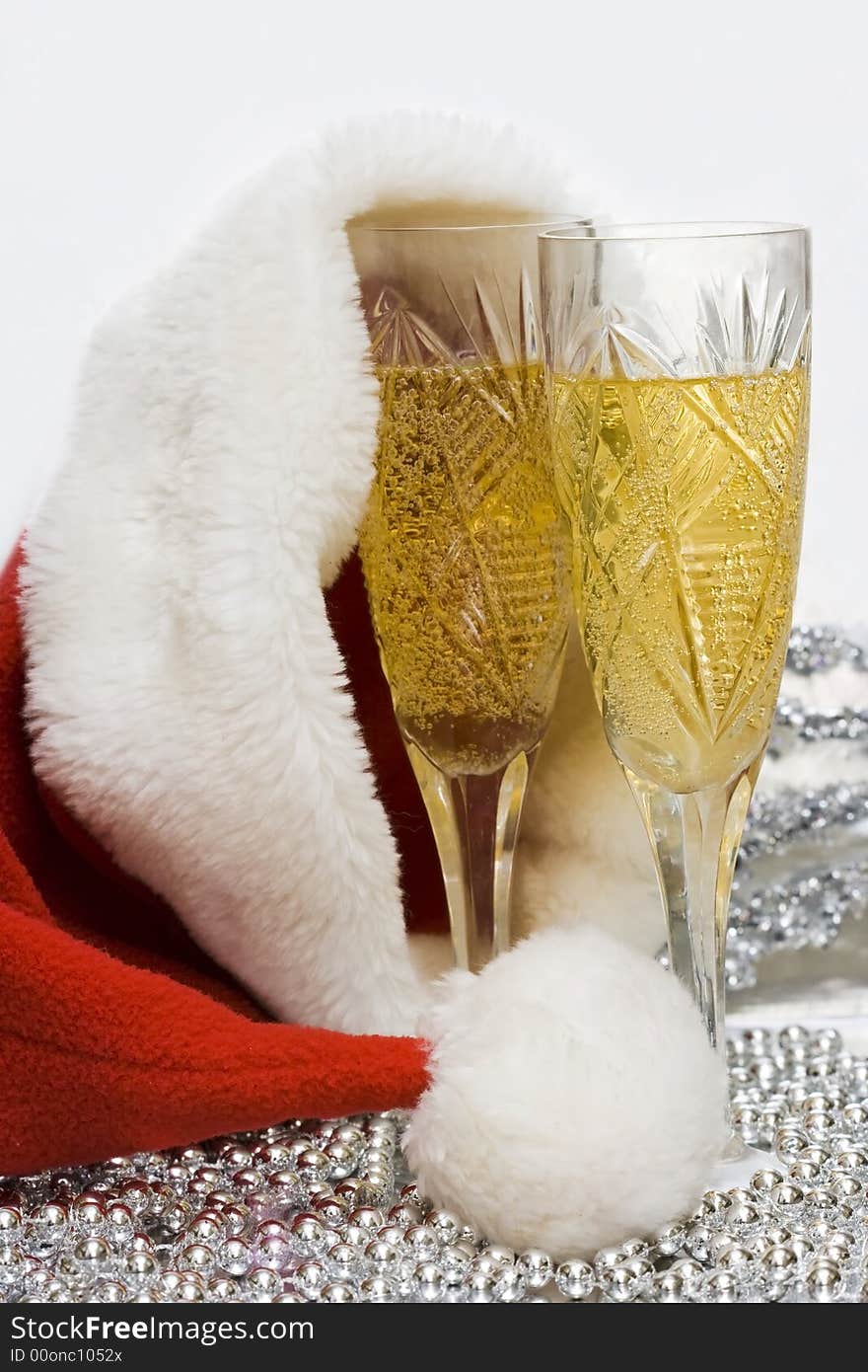 Glasses with champagne with Santa hat