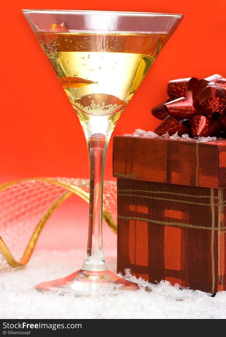 Glass with champagne and gift box