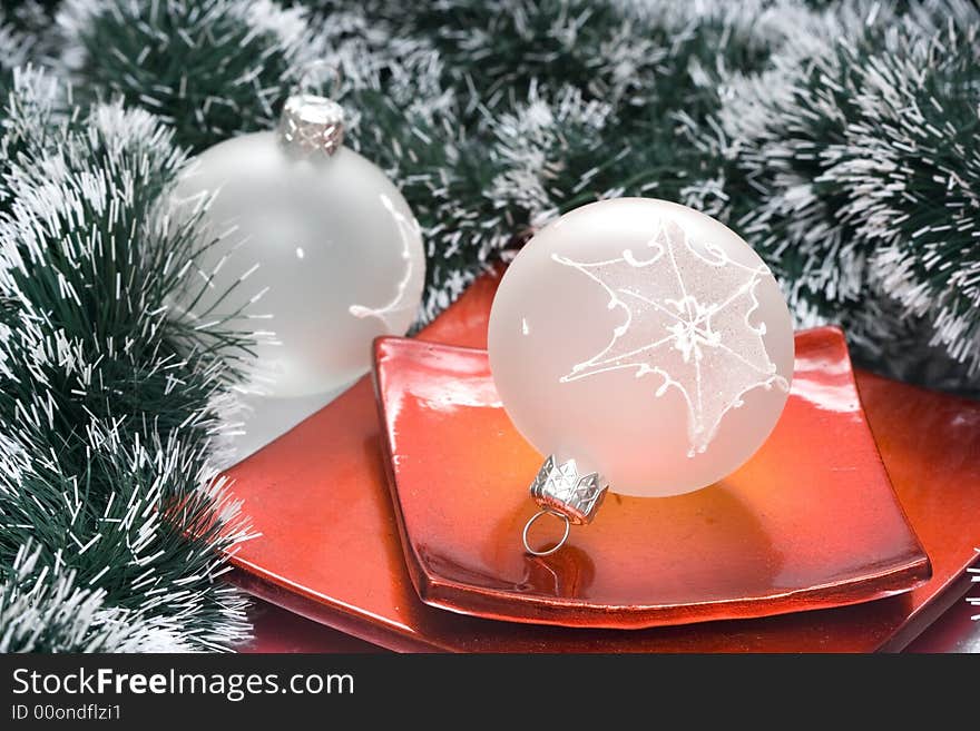 Christmas balls in plate and garland