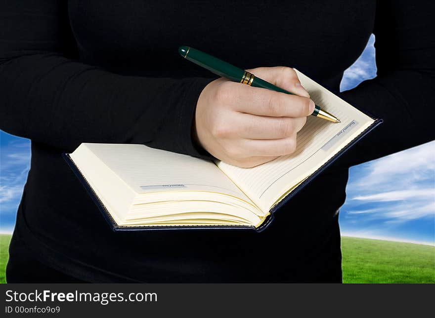 Female hand writing in a notebook