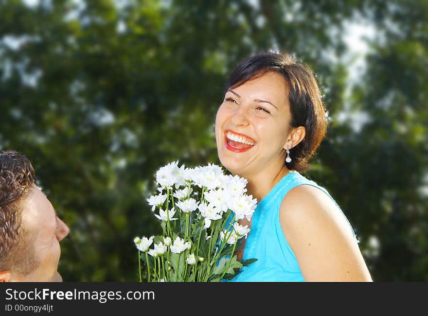 A portrait of attractive couple in summer environment. A portrait of attractive couple in summer environment