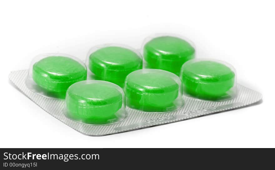 Green cough tablets in closeup on white background. Green cough tablets in closeup on white background