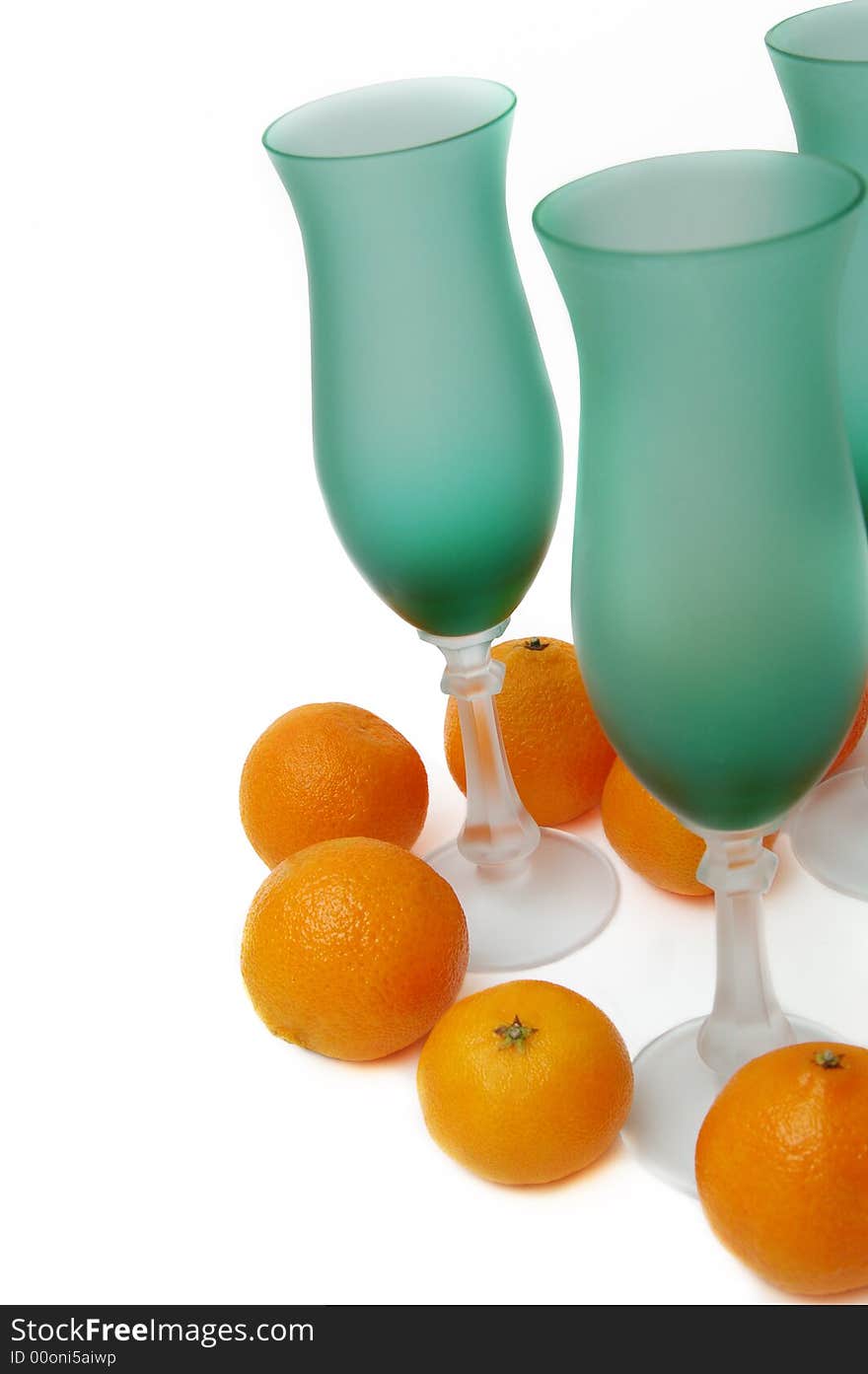 Still-life with green glasses and tangerines isolated