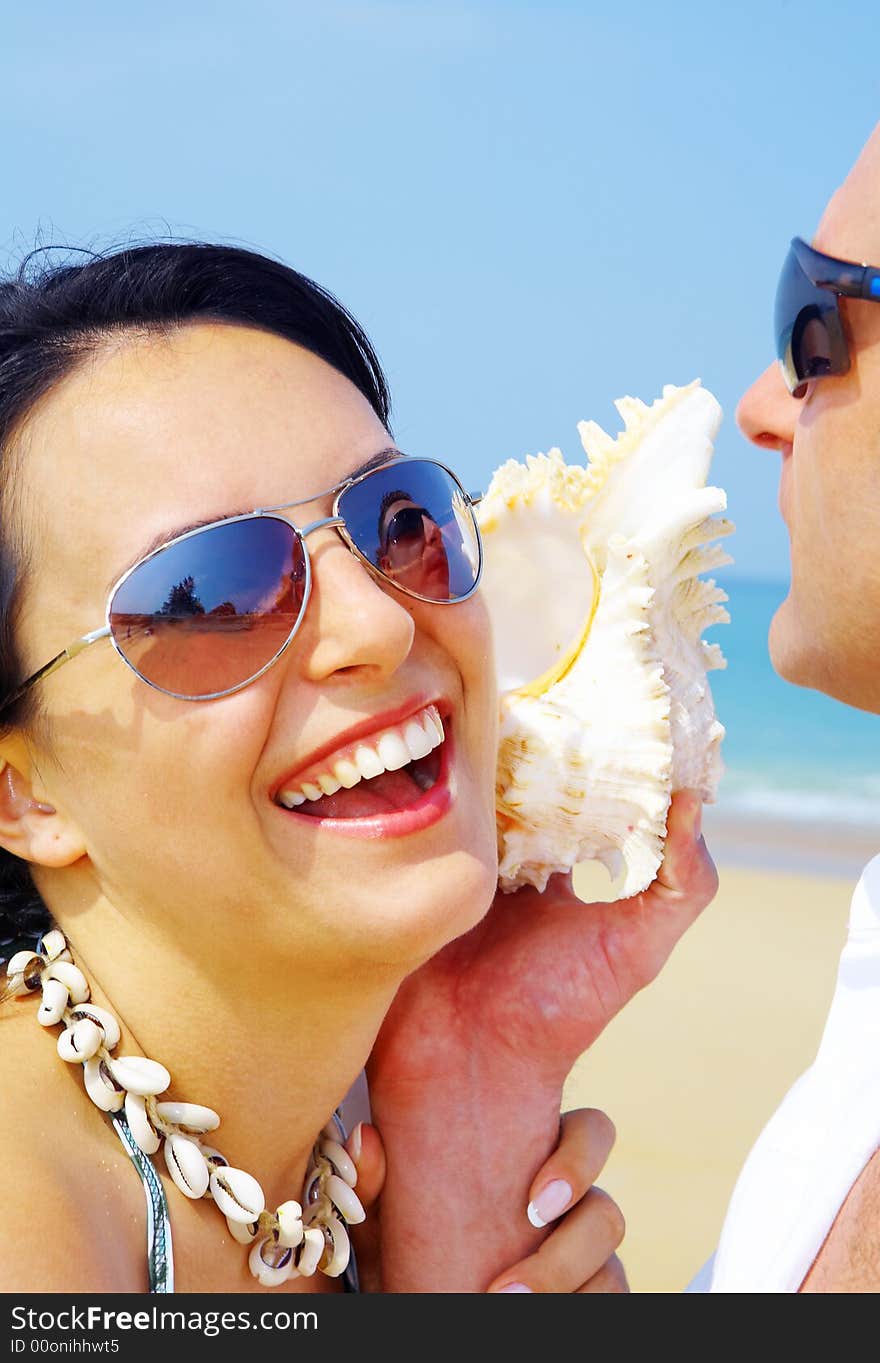 A portrait of attractive couple having fun on the beach. A portrait of attractive couple having fun on the beach