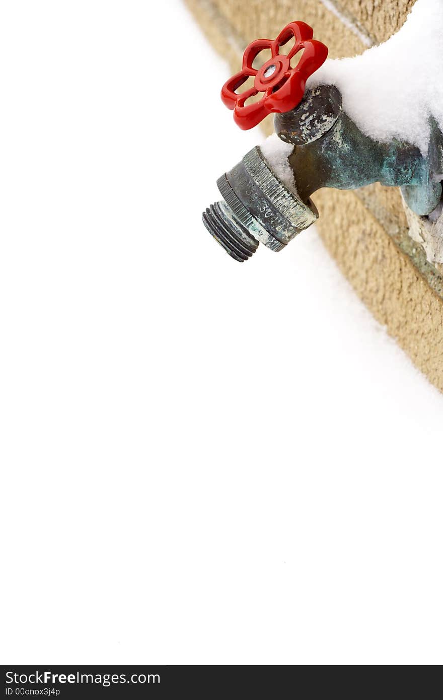 Colorful water tap from a wall against white snow background.