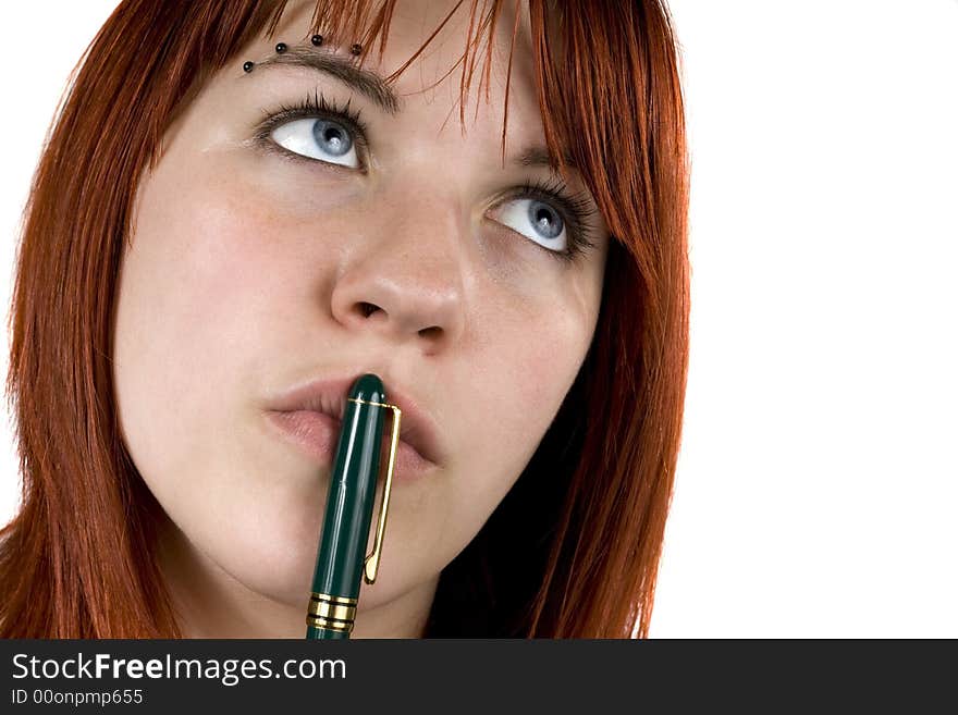 Cute girl with redhair pensive with pen on her lips. Cute girl with redhair pensive with pen on her lips.