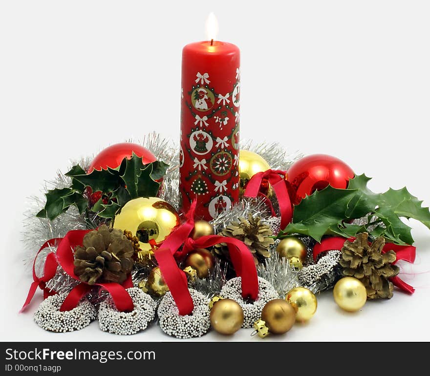 Christmas decoration with burning candle, ornaments and chocolate sweets on ribbons to hang in the tree