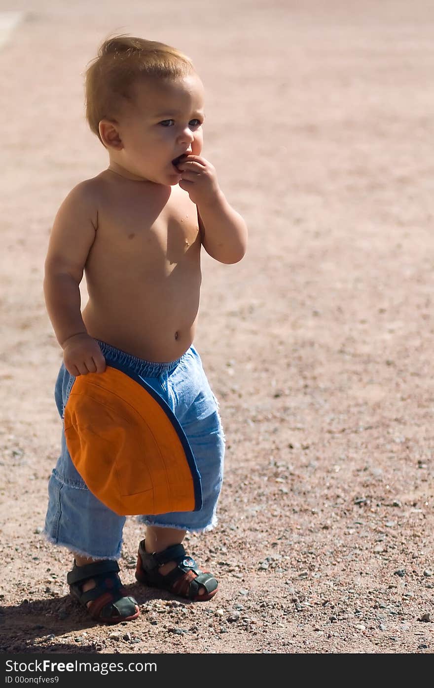 1 year baby eating something at sunny summer day. 1 year baby eating something at sunny summer day