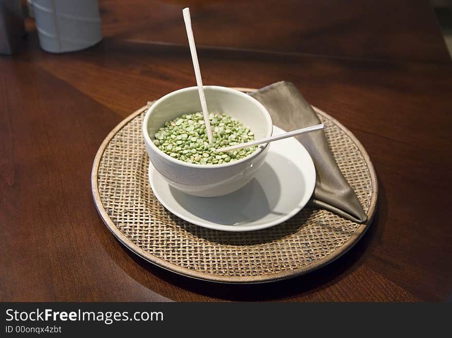 An Asian place setting with a bowl and chopsticks. An Asian place setting with a bowl and chopsticks