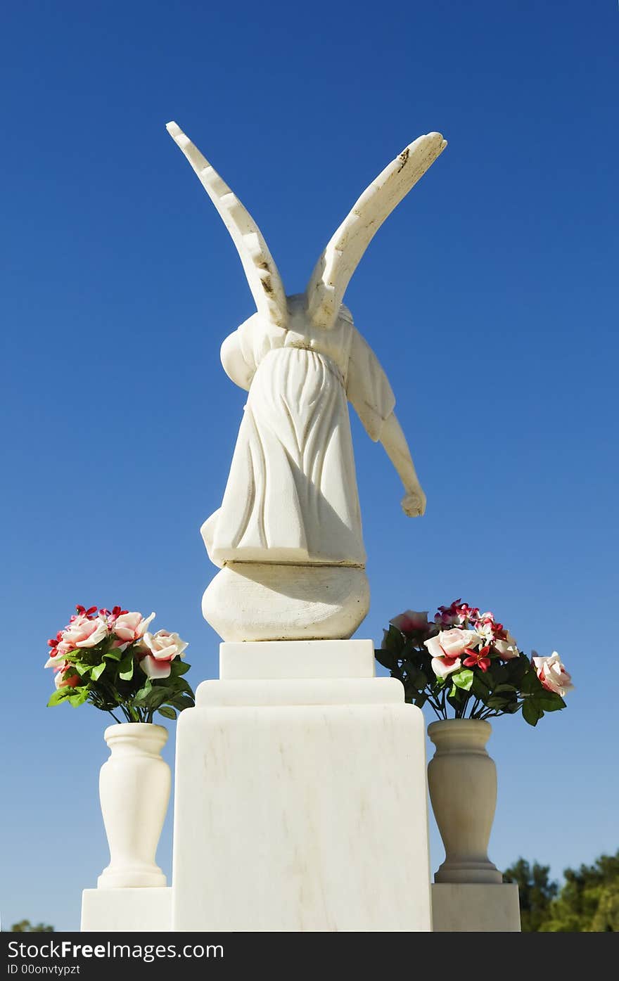 White angel sculpture in a catholic cemetery, Portugal