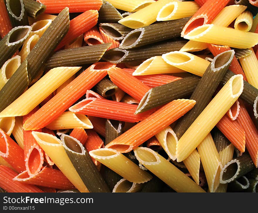 Uncooked tricolor noodle , kitchen background. Uncooked tricolor noodle , kitchen background