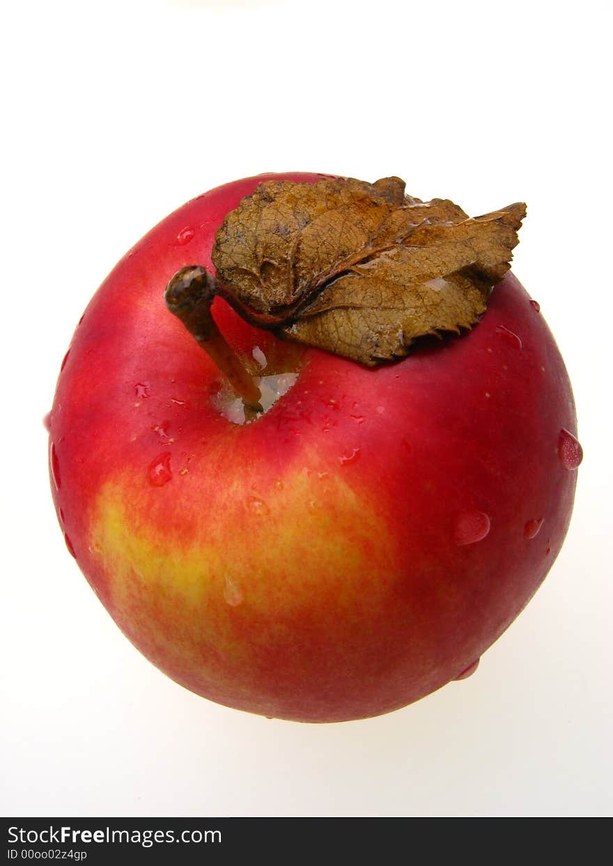 Red apple covered with drops of water on white background, close up