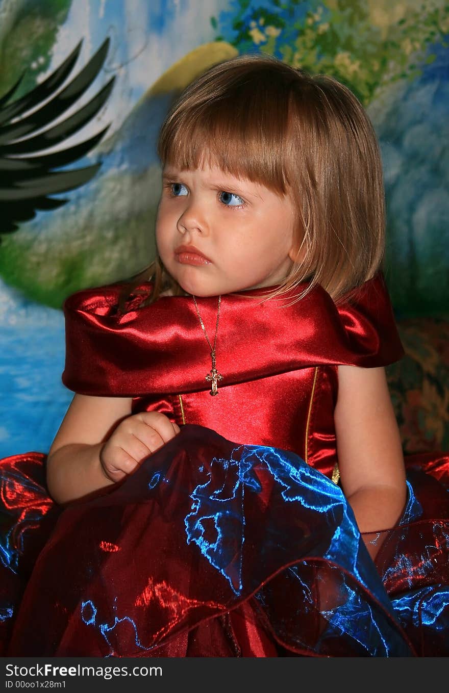 The girl in a beautiful velvet dress. A color background. The girl in a beautiful velvet dress. A color background