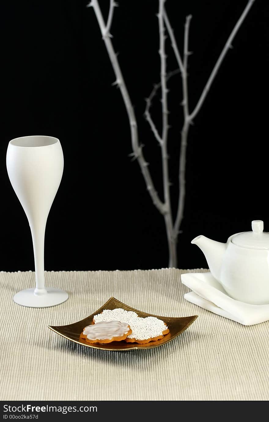 A modern table setting with cookies and tea