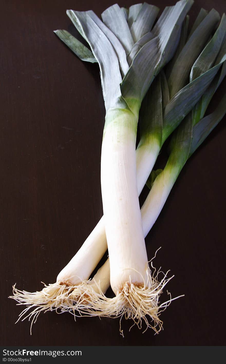 Three leeks on a black background