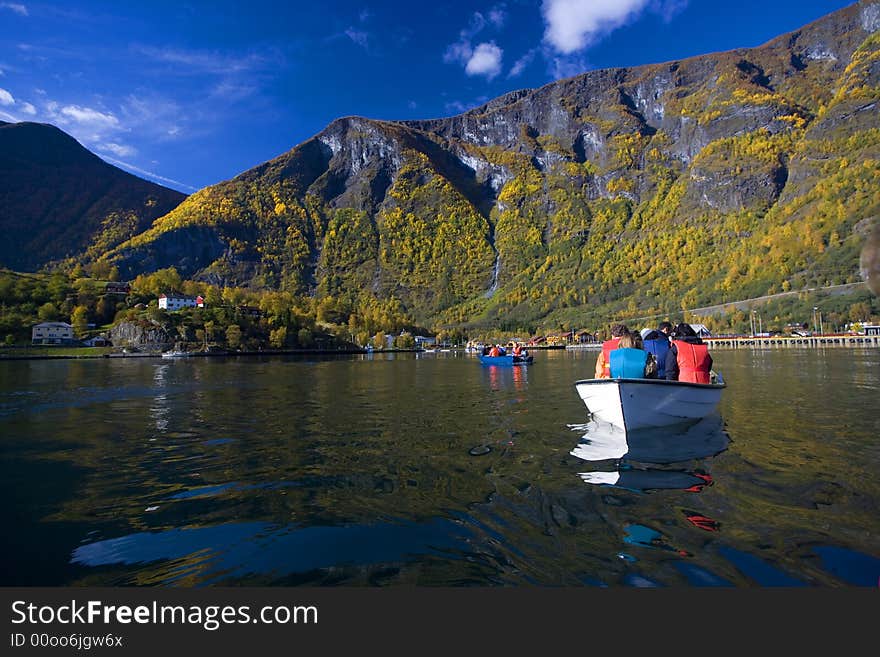 Autumn landscape with boats in the river