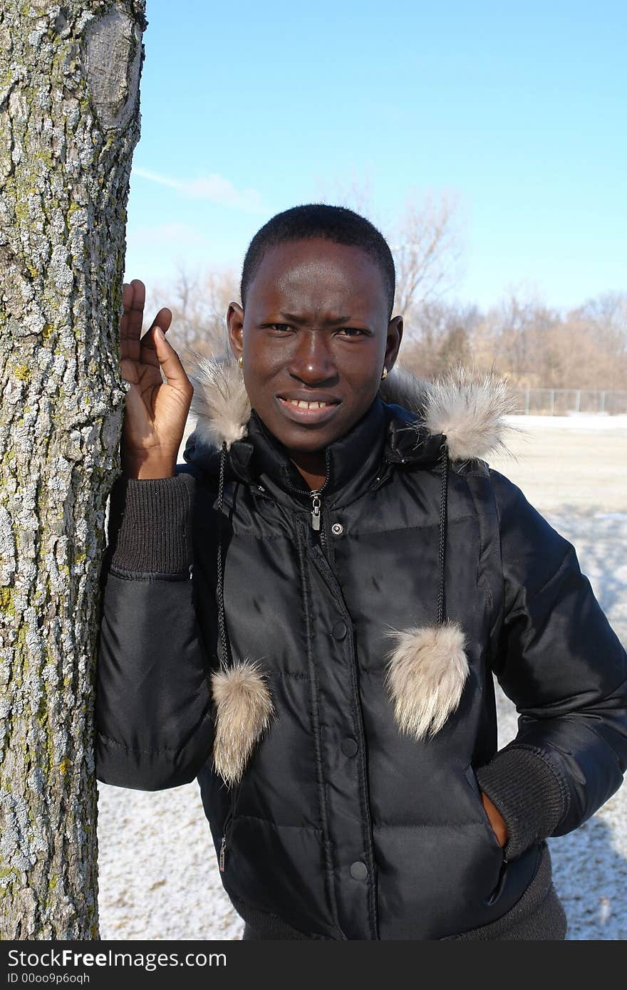 A picture of a African woman in black jacket outdoors