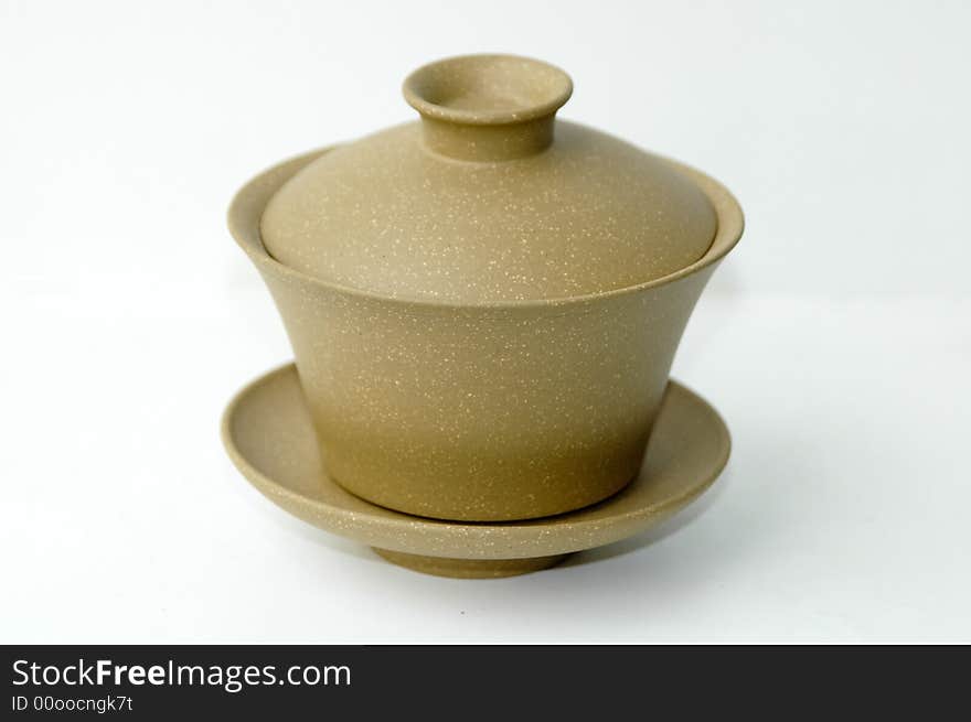 Yellow clay Chinese teacup on white background