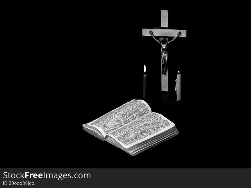 Stark black and white image of a prayer crucifix with two candles set out before a bible open to the book of Jeremiah. Stark black and white image of a prayer crucifix with two candles set out before a bible open to the book of Jeremiah