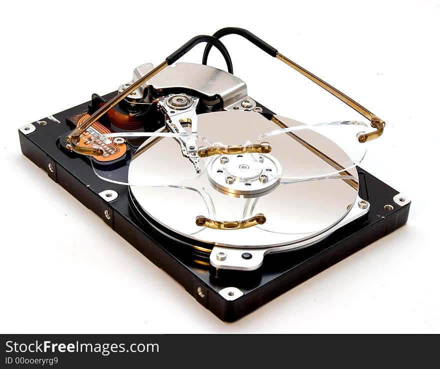 An exposed hard disk drive platter with a pair of glasses on it. An exposed hard disk drive platter with a pair of glasses on it.