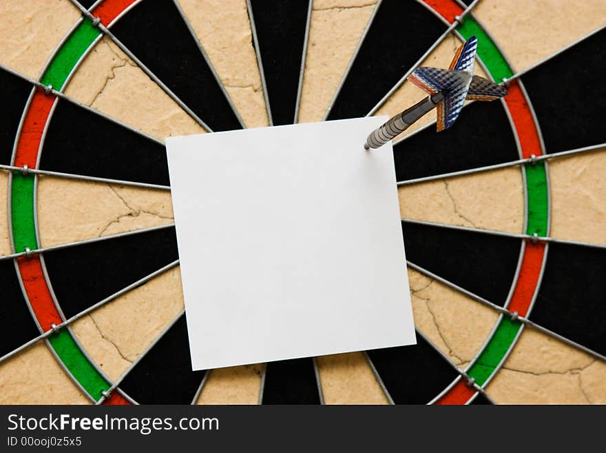 White paper on board. Darts. White paper on board. Darts.