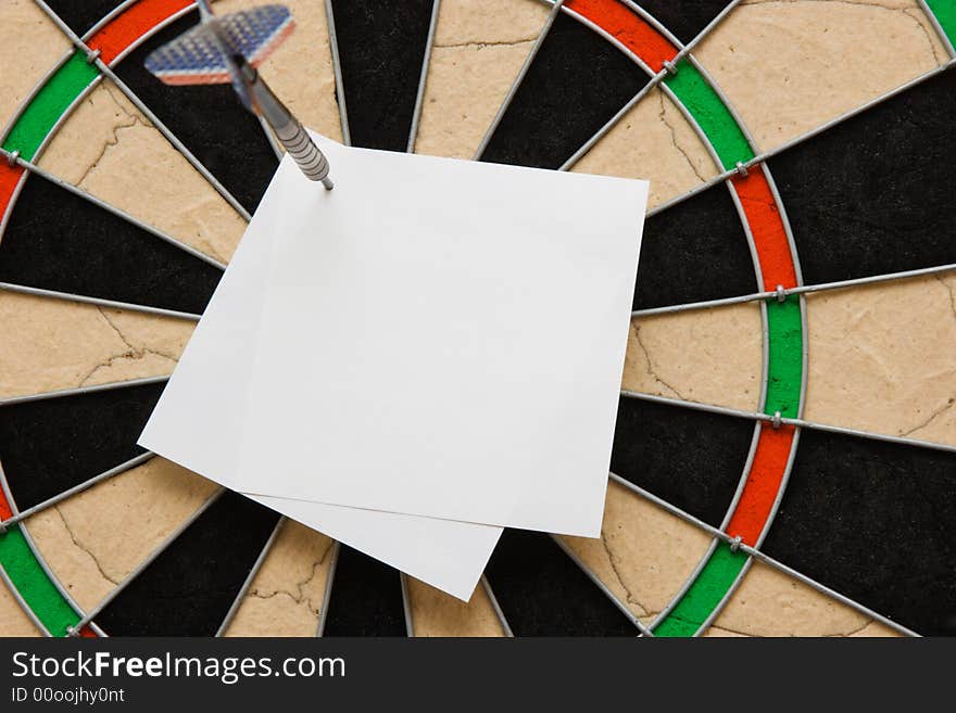 White paper on board. Darts. White paper on board. Darts.