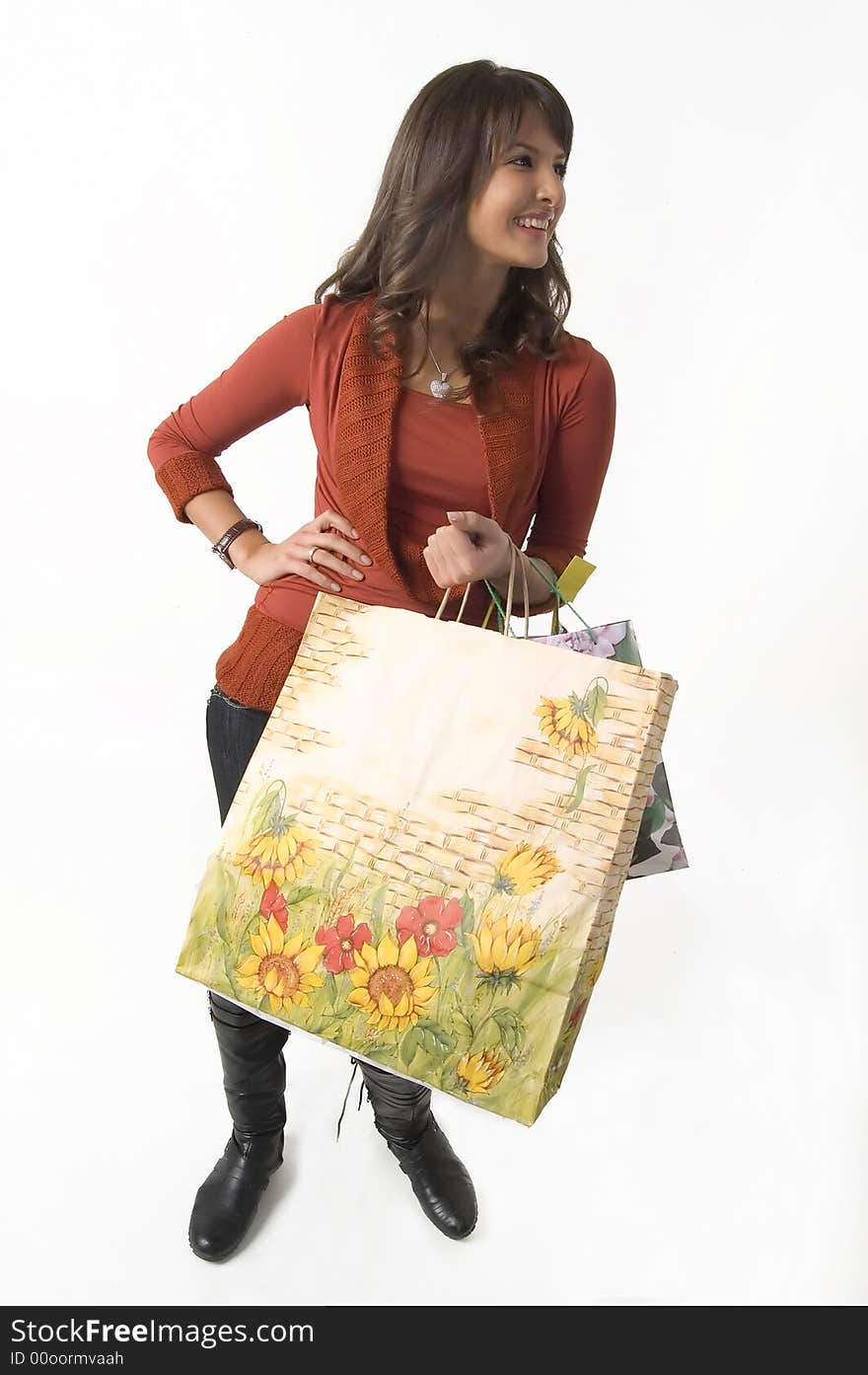 Pretty young woman with green, yellow and beige shopping bags. Pretty young woman with green, yellow and beige shopping bags