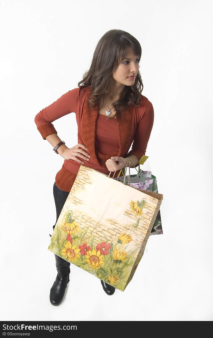 Pretty young woman with green yellow and beige shopping bags. Pretty young woman with green yellow and beige shopping bags