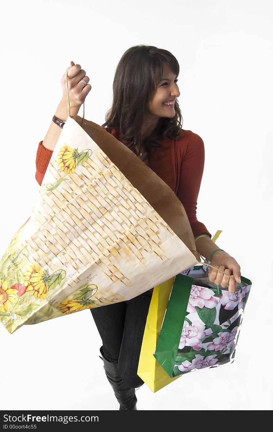 Pretty young woman with green yellow and beige shopping bags. Pretty young woman with green yellow and beige shopping bags